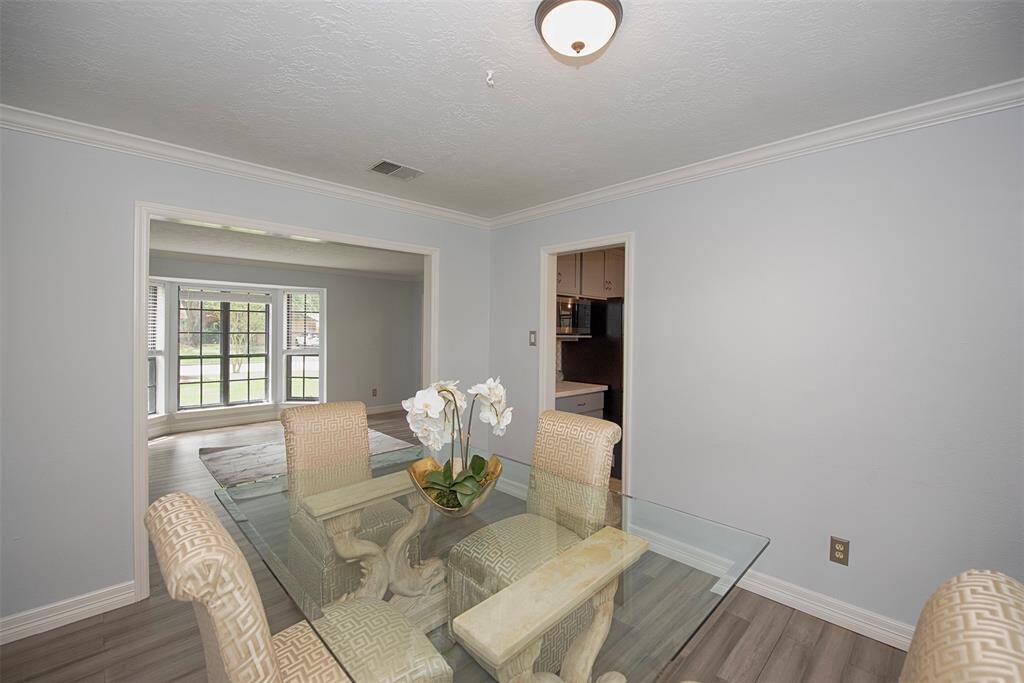 A view of the formal dining area open to the living area as well as easy access to the kitchen.