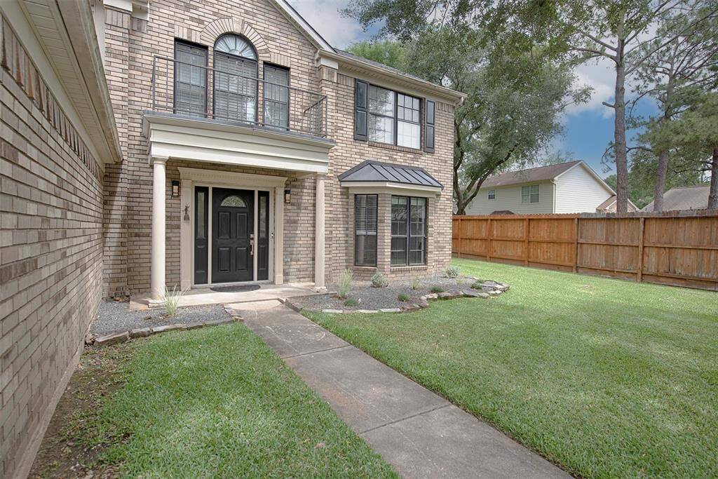 Inviting walkway to the front porch with rock accented landscaping and stone gravel rather than traditional mulch. Certain last longer.