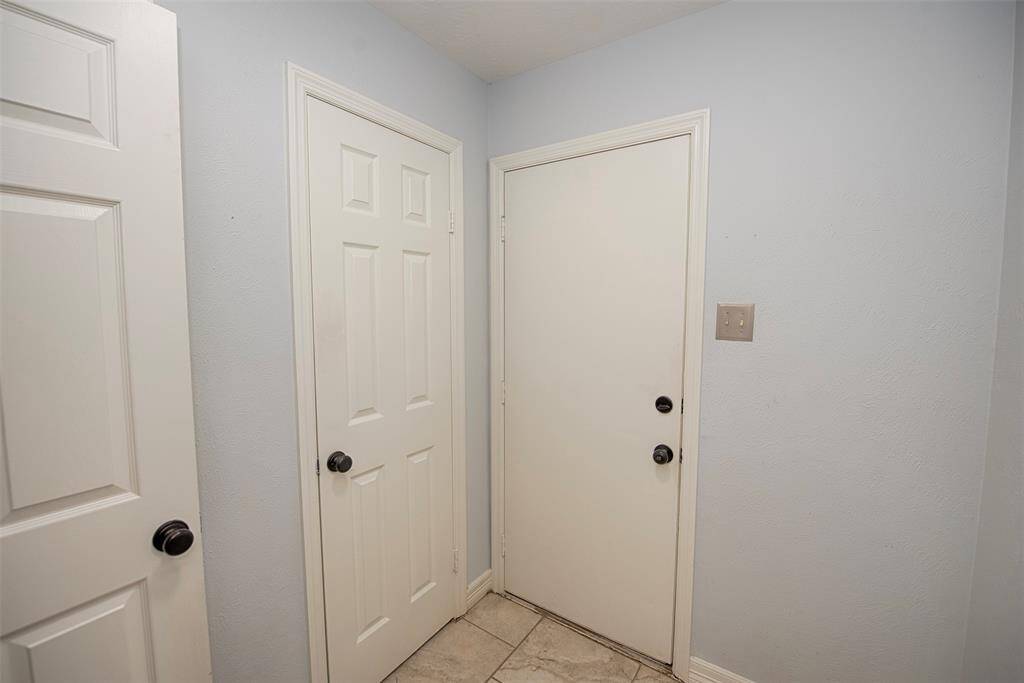 On your way to the garage and the utility room is space as well as secondary closet. Perfect for storing your vacuum and household cleaners.