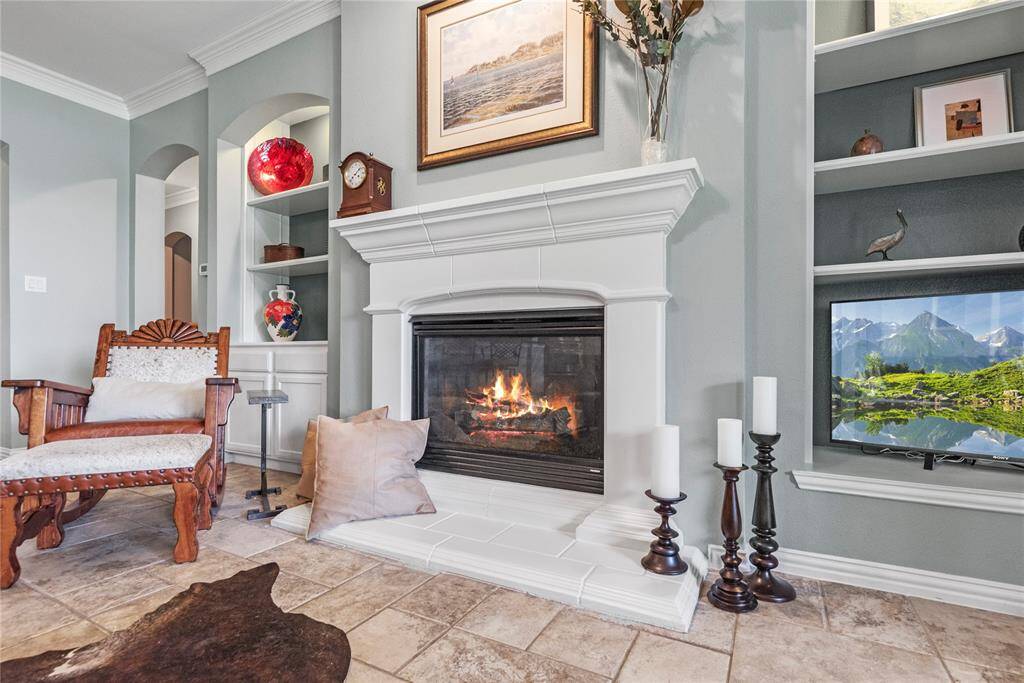 Close up view of the family room showcasing the cast stone gas fireplace.