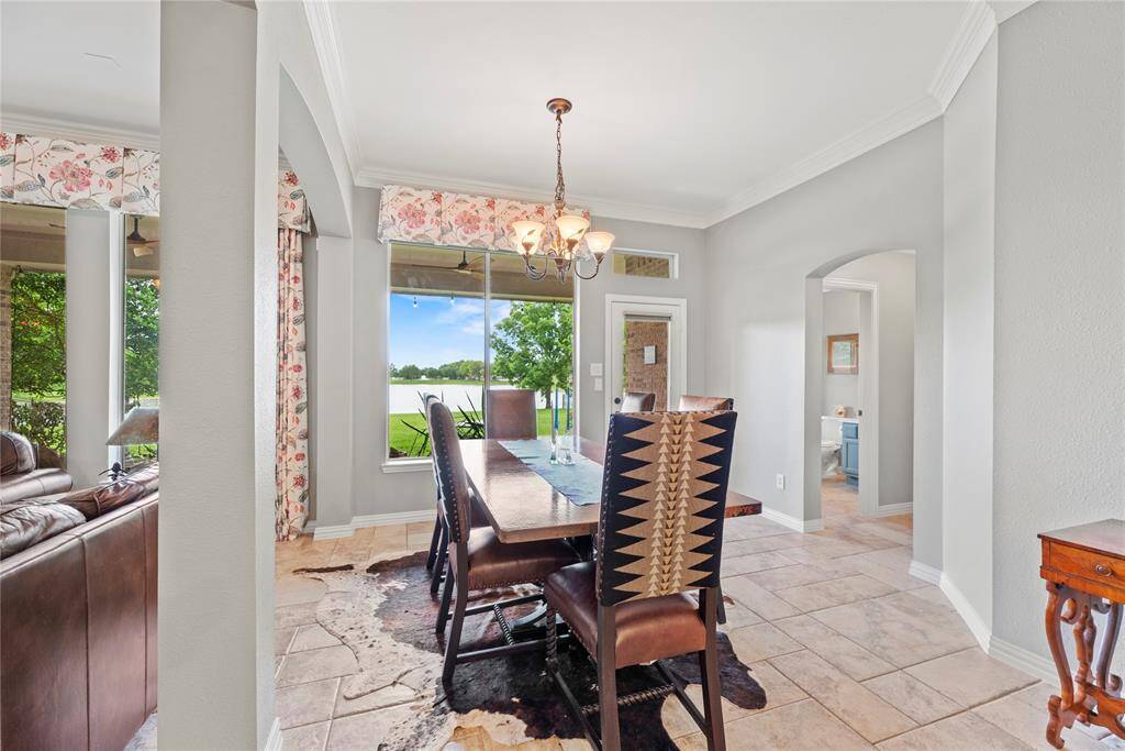 View from the kitchen into the breakfast nook, featuring large windows with scenic views of the backyard and lake.