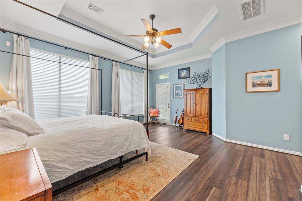 Alternate view of the primary bedroom with door leading to the rear covered patio and rear yard with lake views.