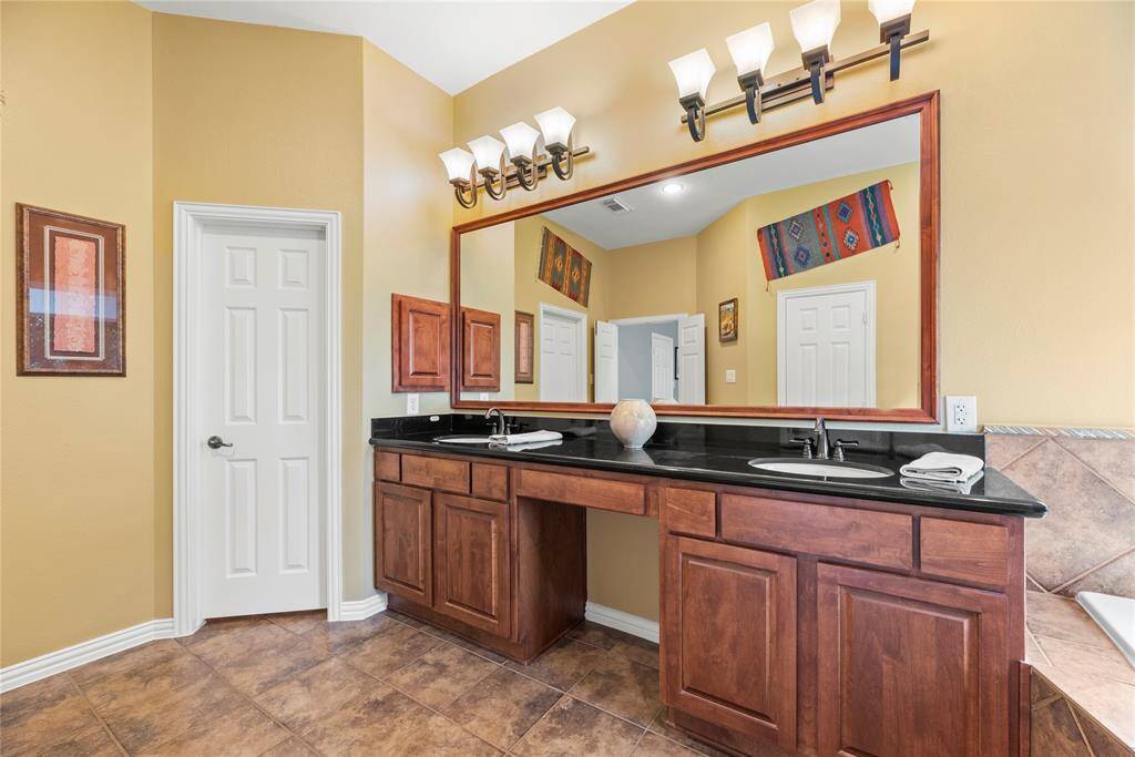 Primary bathroom features a double vanity and 2 undermount sinks.