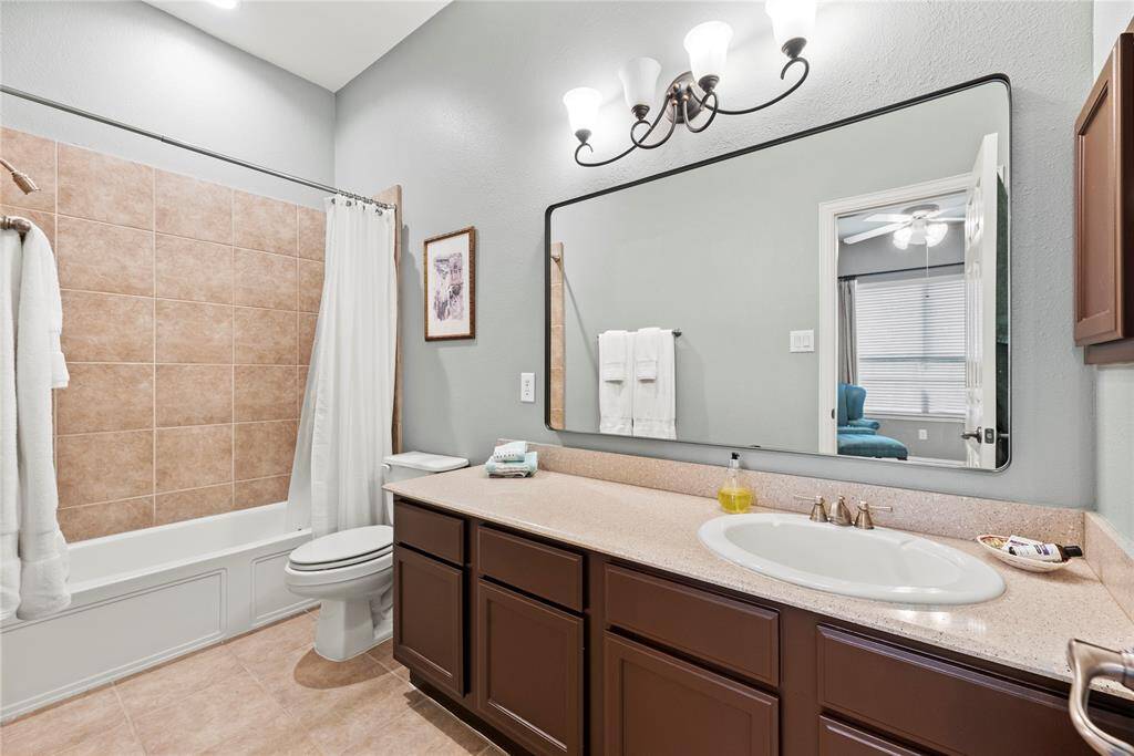 Bathroom # 2 that features a large countertop, a sink, and a large mirror.