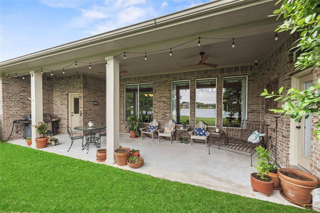 Spacious covered patio offers scenic lake views and has a ceiling fans.