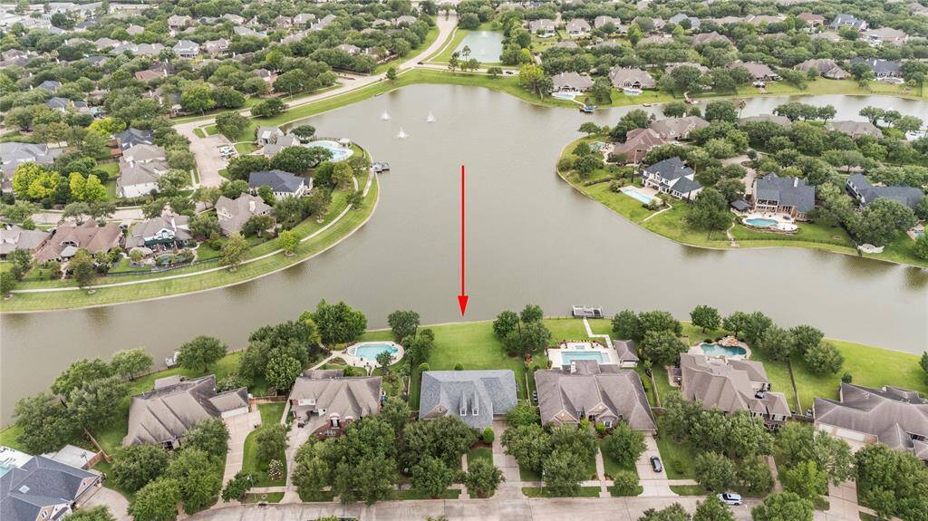 Aerial view of the property highlighting the amazing length of the lake this home overlooks every day!