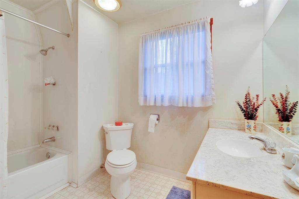 Upstairs bathroom with tub and shower.