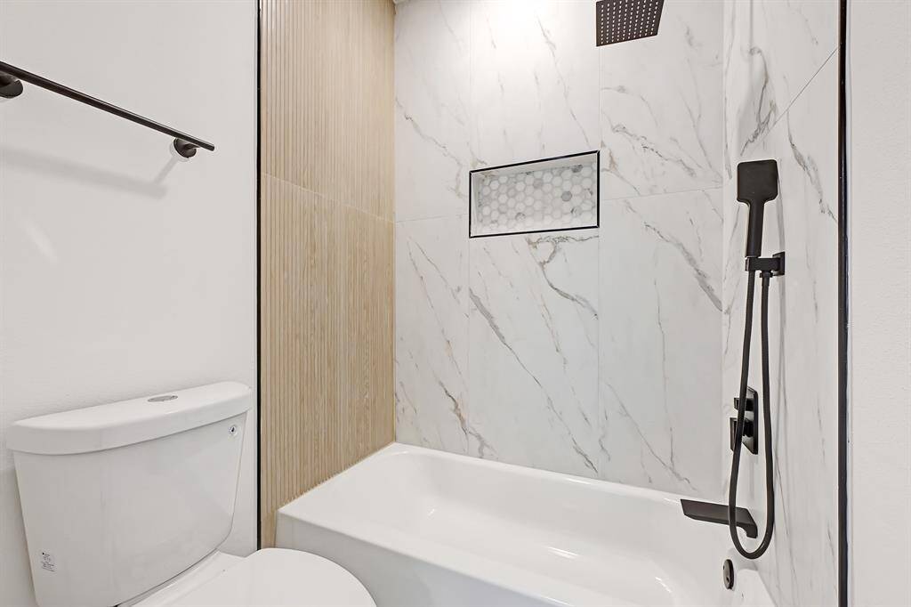 Sleek and modern bathroom featuring elegant tilework and a sophisticated shower design.