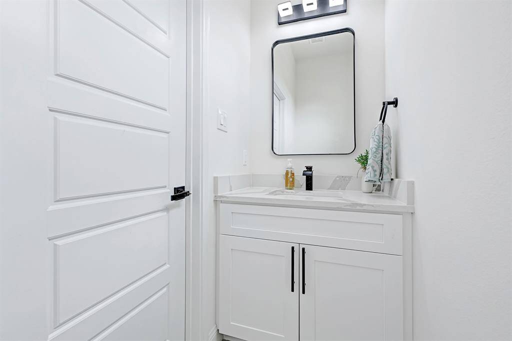 Elegant bathrooms sink with a modern vanity, sleek fixtures, and a stylish mirror.