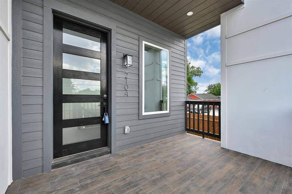 Charming front porch offering a warm welcome with modern design and ample space to relax.