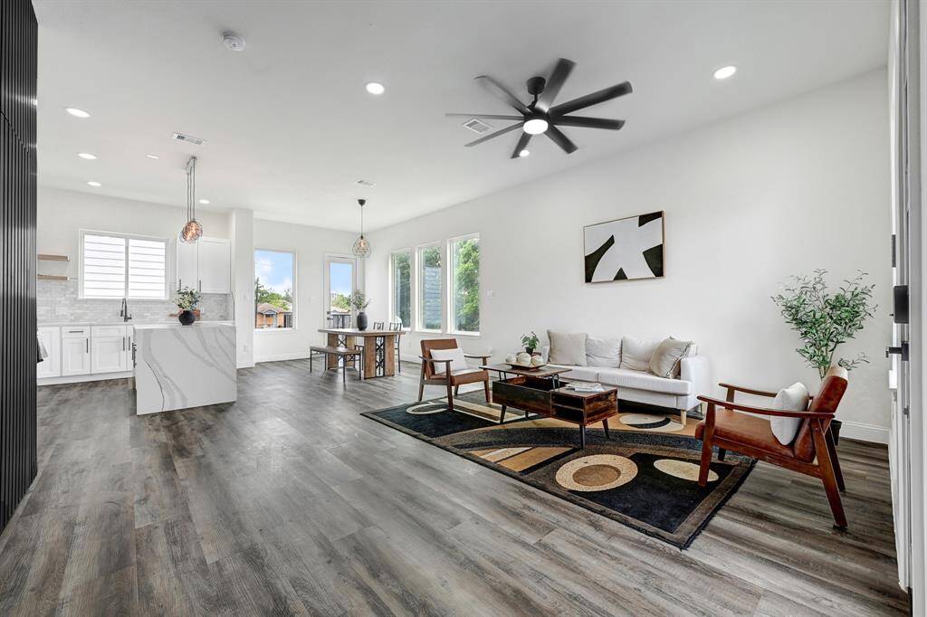 Spacious open concept living area seamlessly connects to a modern kitchen.