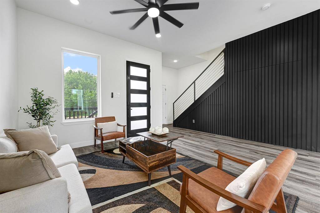 Stylish living room featuring elegant stairs and a modern aesthetic.