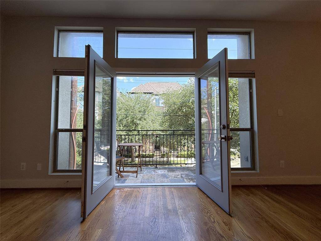 French doors open in from the balcony. Tree-top view!