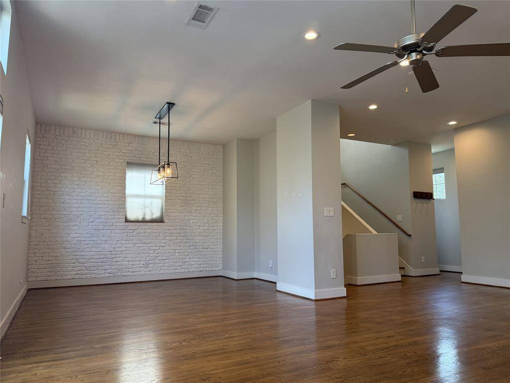 The dining room with faux brick wall & cabinet niche.