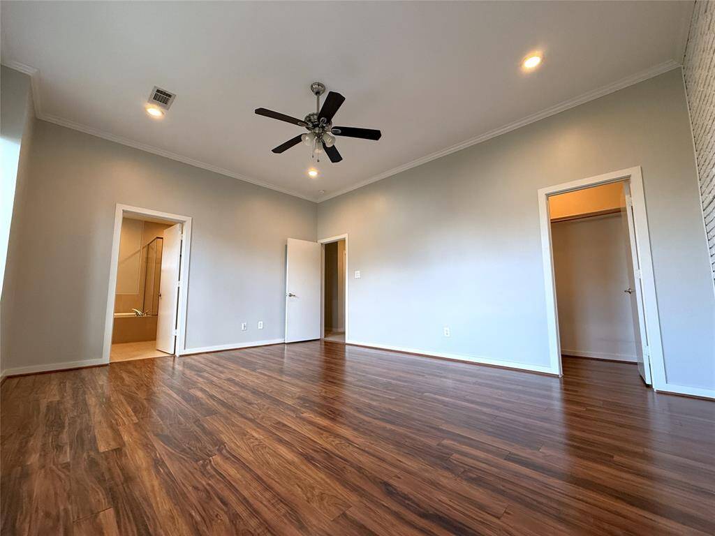 Alternate view of the primary bedroom. On the far right, the door opens into the 1st walk-in closet.