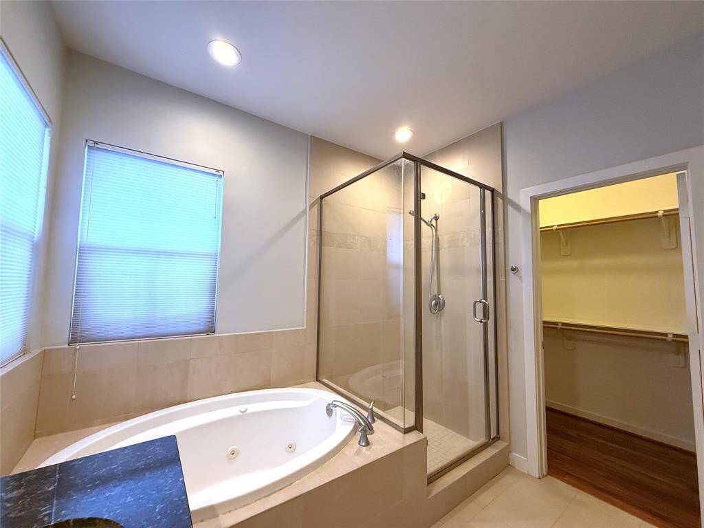 Jetted tub, glass framed shower & 2nd walk-in closet.