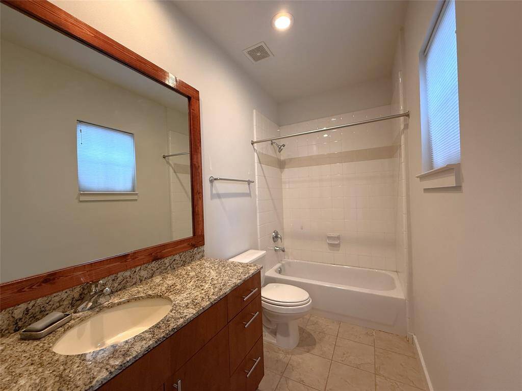 Tub/shower combo, nicely sized vanity with storage.