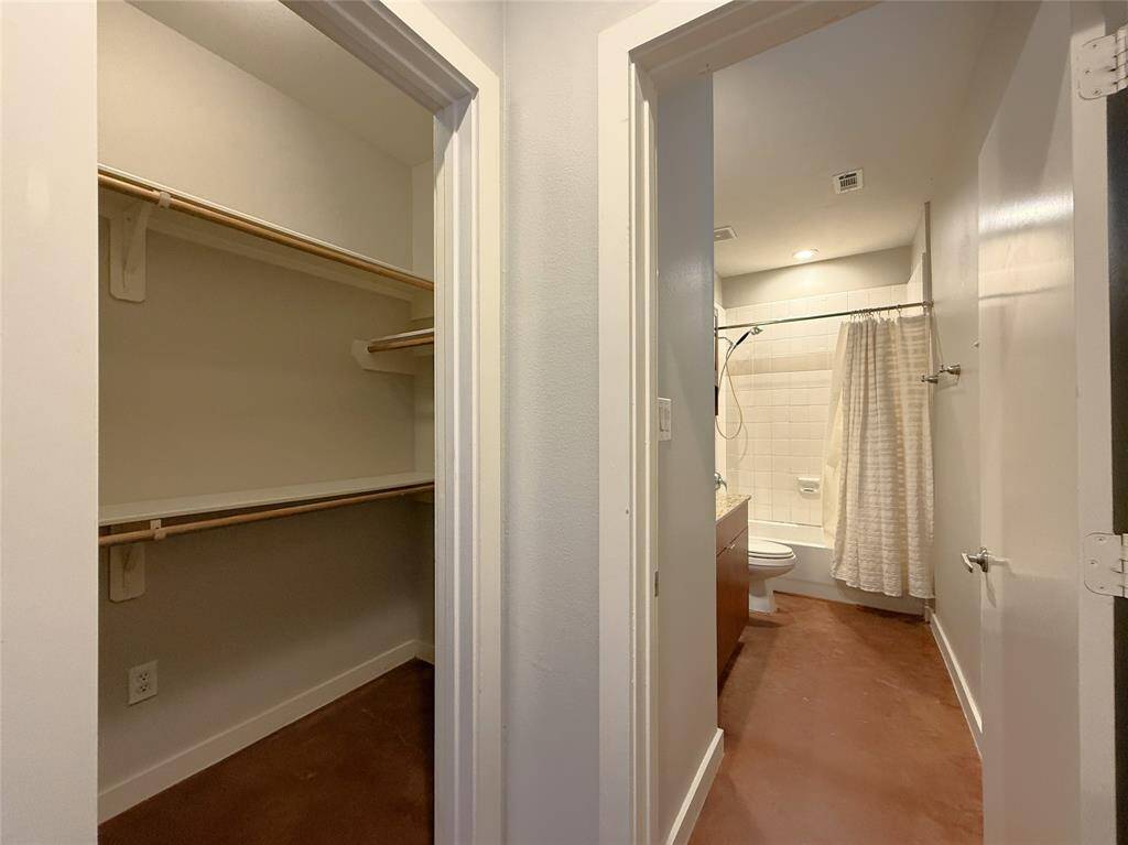 In the first floor bedroom, conveniently located by the en-suite bath, a pocket door opens to the step-in closet.