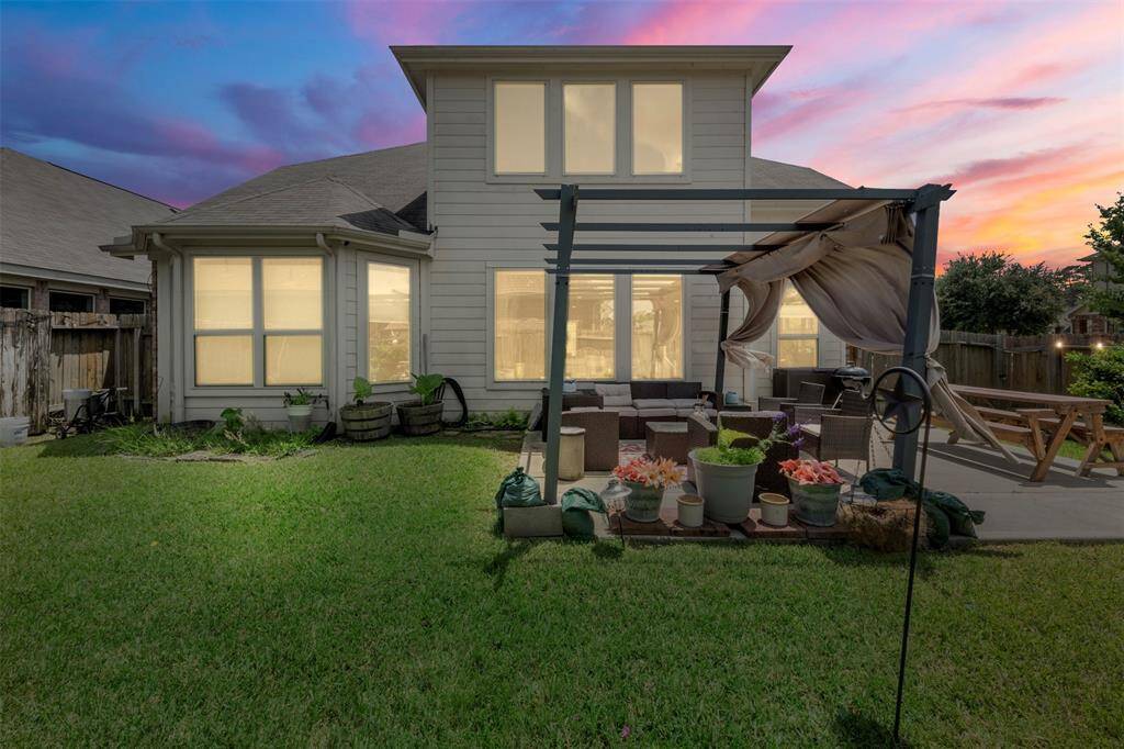 A stunning twilight view of the rear elevation of the home.