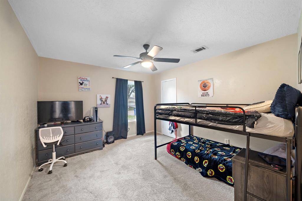 Spacious third bedroom with natural light, perfect for a cozy retreat or versatile office space.
