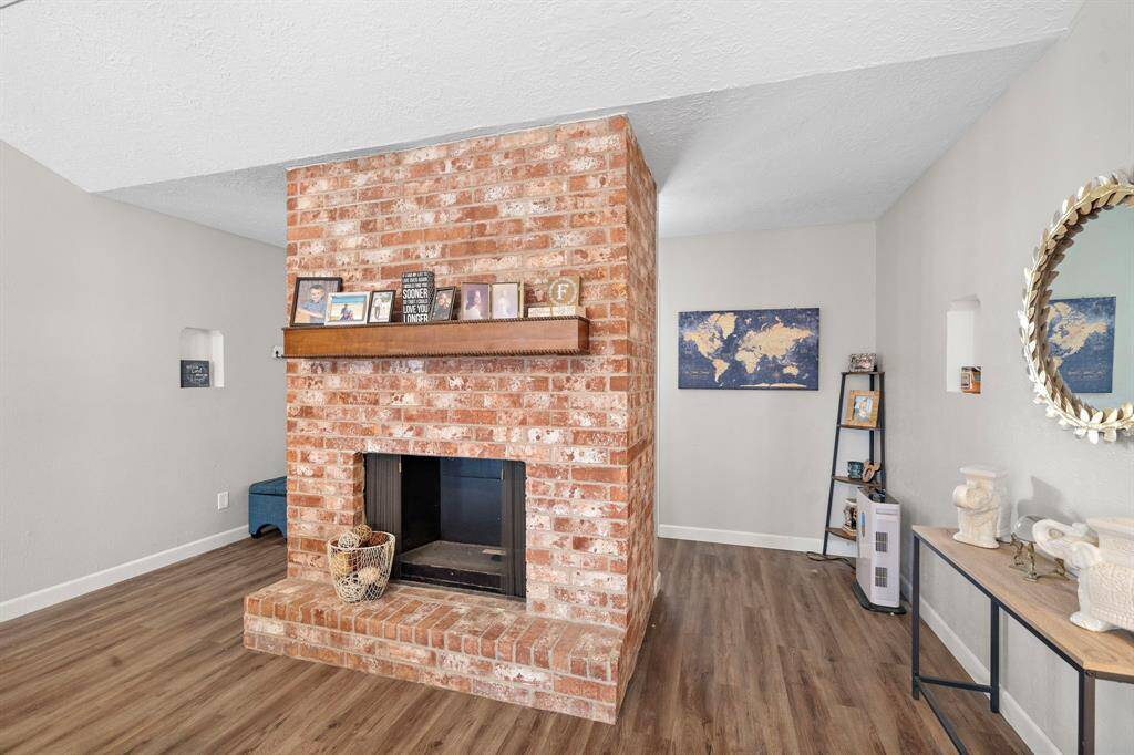 Charming central brick fireplace, perfect for cozy gatherings.