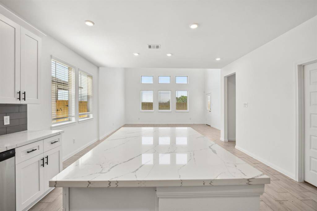 Notice how the open layout effortlessly connects the kitchen to the spacious living area, creating an ideal flow for gatherings and everyday life.
