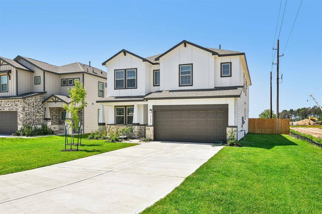 Imagine pulling into this spacious driveway, greeted by the fresh green lawn and the charming modern farmhouse aesthetic.