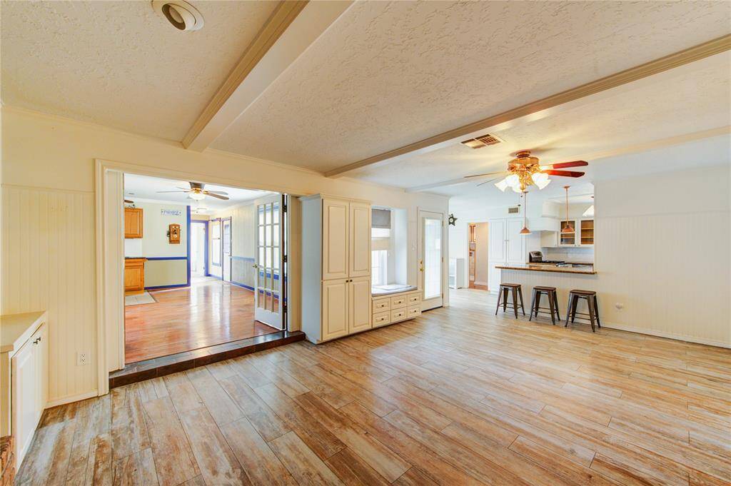 This open-concept floor plan flows beautifully from the updated kitchen and breakfast area into a spacious living room with built-ins and a cozy window seat