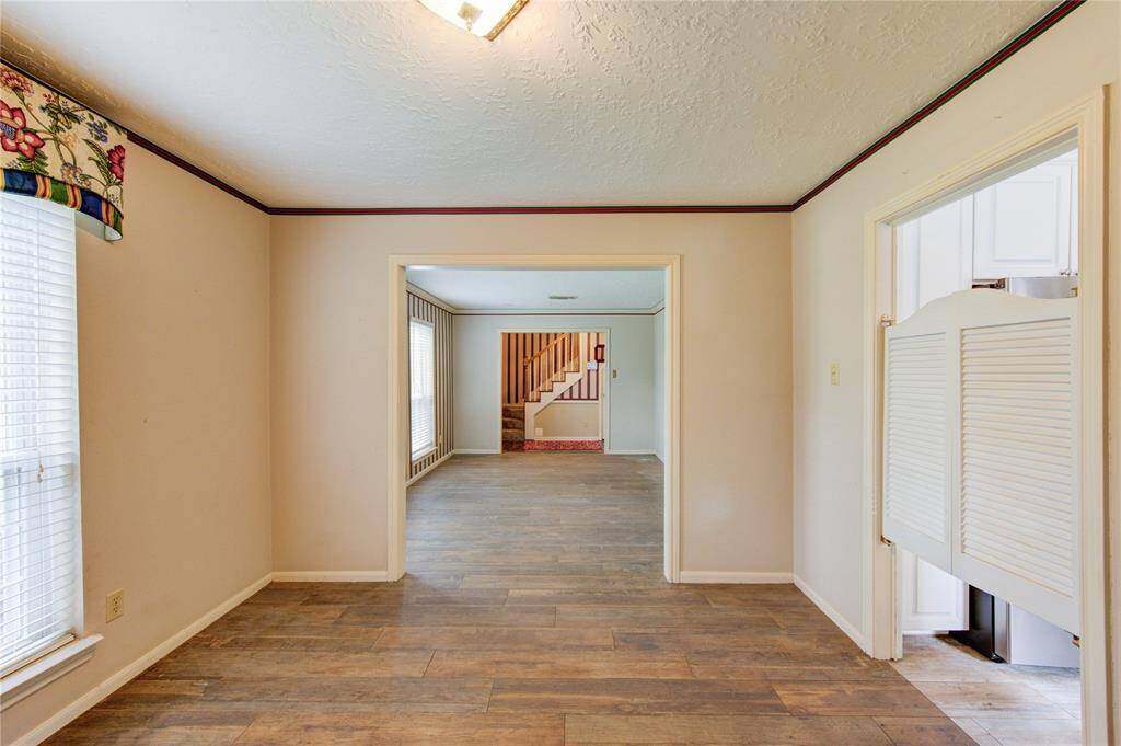 The dining room is centrally located with natural light from multiple windows