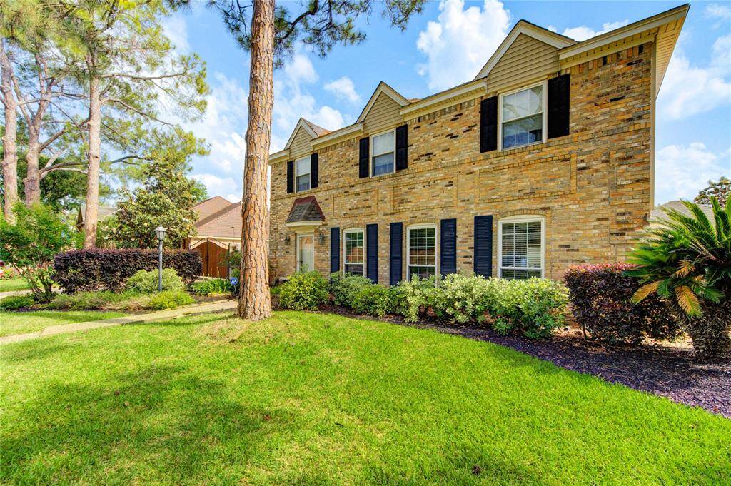 The classic black shutters and brick exterior on this traditional style two story