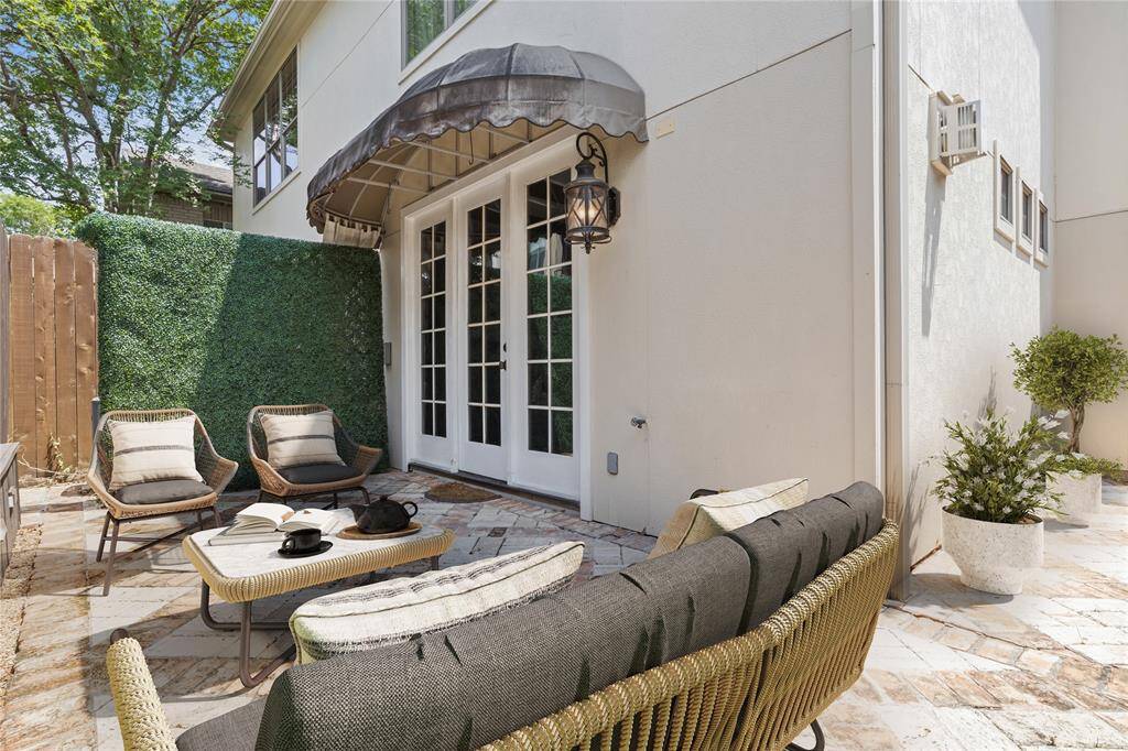 Step outside to a charming brick patio just off the living room—ideal for morning coffee, evening cocktails, or a quiet moment under the open sky. With its privacy wall and French door access, this outdoor retreat feels like an extension of the home’s warm, inviting atmosphere.*Virtual Staging