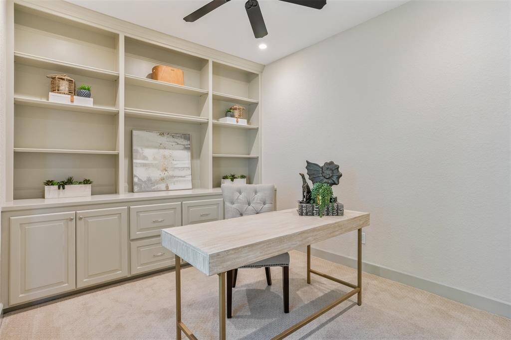 Whether you work from home or simply crave a quiet space to focus, this dedicated office delivers. Built-in shelving and cabinetry offer smart storage and display options, while soft carpet underfoot and recessed lighting create a calm, productive atmosphere.