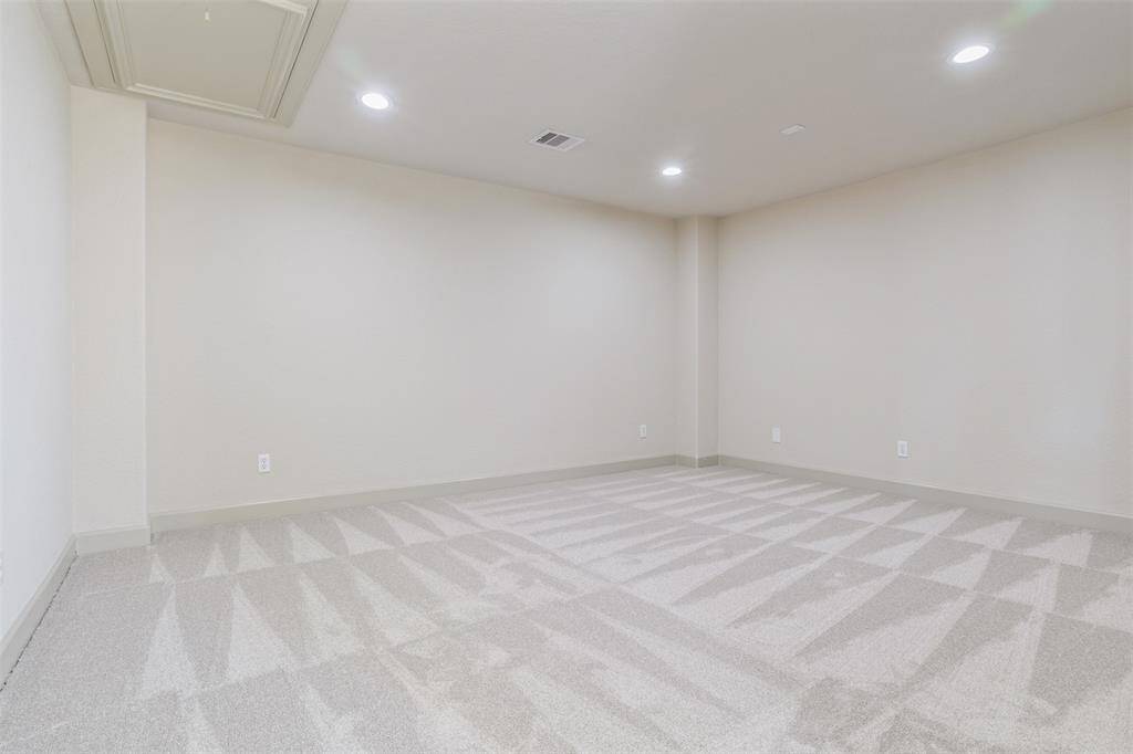 Here is the same third-level flex space shown without virtual staging, highlighting its generous proportions, clean lines, and double-door entry. Whether used as a home gym, office, media room, or guest retreat, this space offers privacy and adaptability to meet your lifestyle.