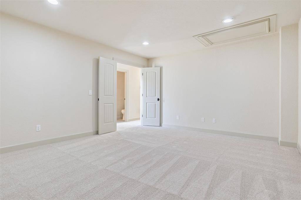 Here is the same third-level flex space shown without virtual staging, highlighting its generous proportions, clean lines, and double-door entry. Whether used as a home gym, office, media room, or guest retreat, this space offers privacy and adaptability to meet your lifestyle.
