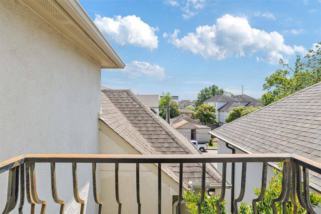 This Juliet balcony, perched on the third level of the home, offers a charming vantage point to enjoy fresh air and sky views—perfect for morning light or a quiet moment above the neighborhood.