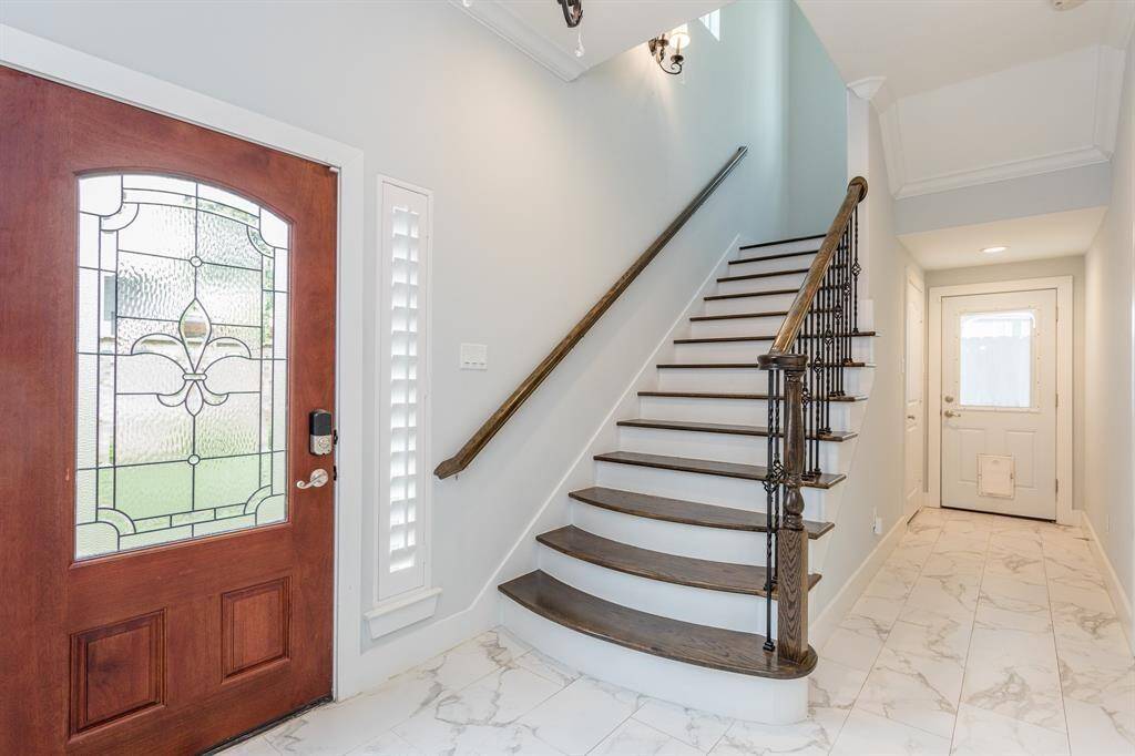 The beautiful back wing of the home is where you’ll find the front door from the gated side entrance. The back door with pet access leads to the turf-laid backyard. Grand staircase leads up to the 2nd story.*Tenant occupied until 05/31/25.*