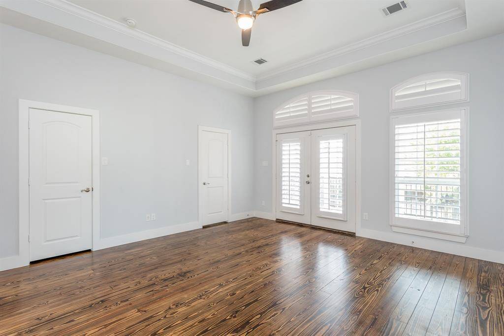 The primary suite with attached balcony that must be seen in-person to give it justice. Trayed ceiling with recess lighting + remote-controlled ceiling fan light. French doors and custom shutters open to the terrace-like balcony.*Tenant occupied until 05/31/25.*
