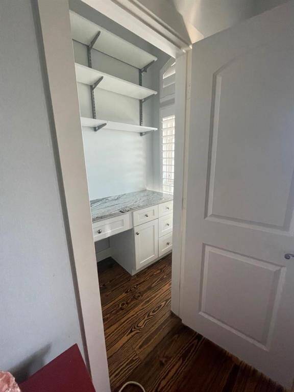 Another door in the primary bedroom (in addition to the 2 closets and private primary bath) opens to a private office/vamity area with a built-in area including its own window, plantation shutters, and plentiful storage.