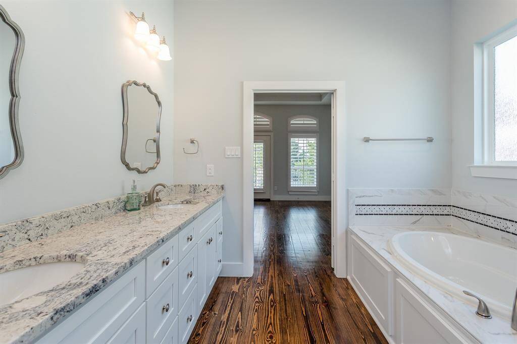 Opposite view of primary bathroom, showing how the double doors from the bedroom open to your personal luxury in-suite bath.