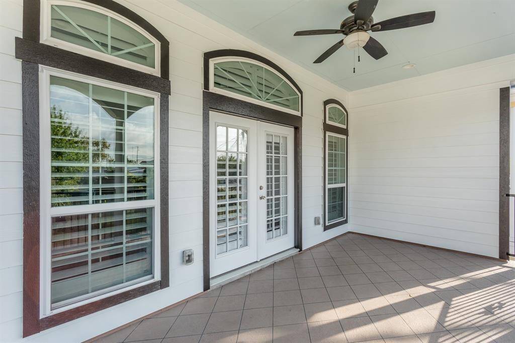 Elegant French doors and arched transom windows lead from the primary suite to a private balcony retreat—perfect for relaxing in style with morning coffee or evening breezes.