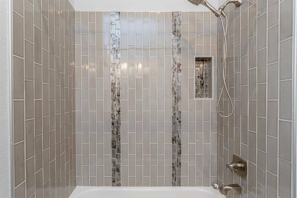 A better view of the tub/shower combo in this upstairs secondary bath.