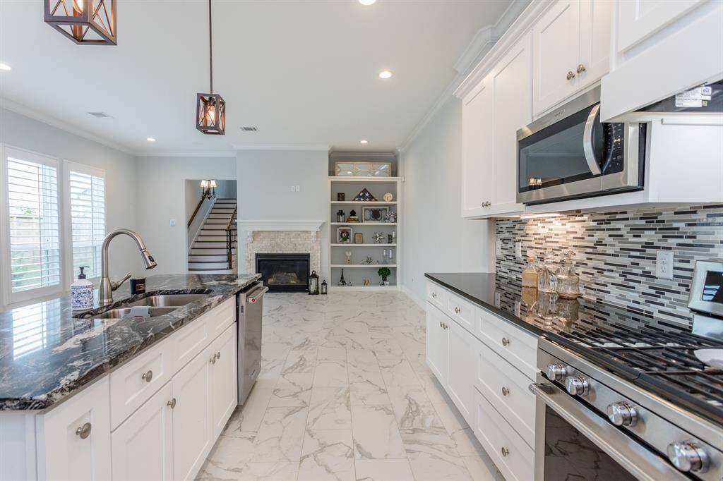 The first floor hosts the open-concept kitchen, dining and living room. Additionally, one bedroom and attached full bath are located on the first floor, at the back wing of the home.