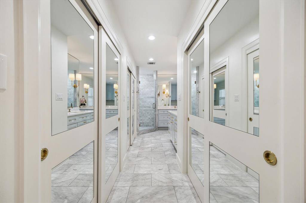 Walls of closets as you enter the all marble primary bathroom.