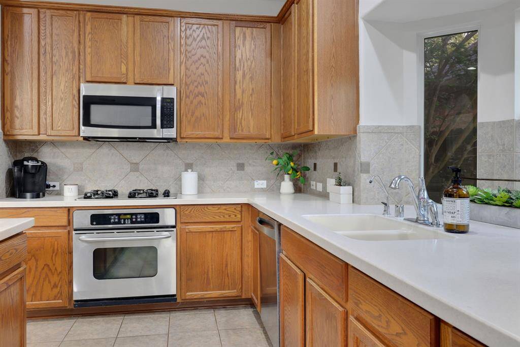 Check out the charming window in front of the kitchen sink w/room for plants