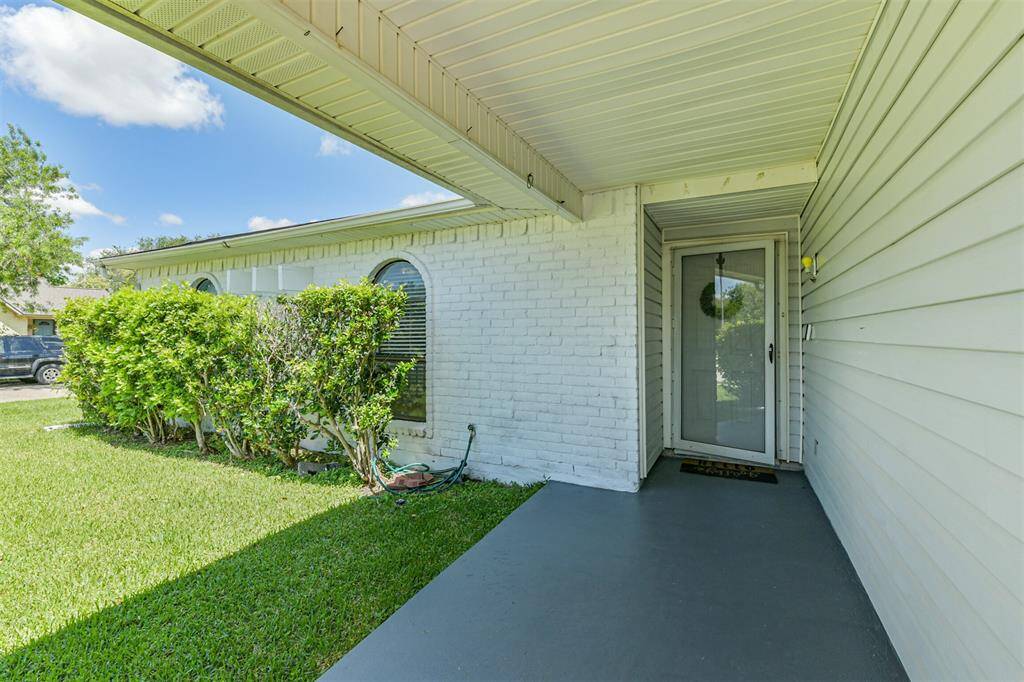 Recently painted covered porch with storm door