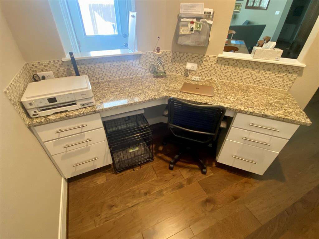 Computer nook adjacent to the kitchen and breakfast area. Plenty of storage for organization!