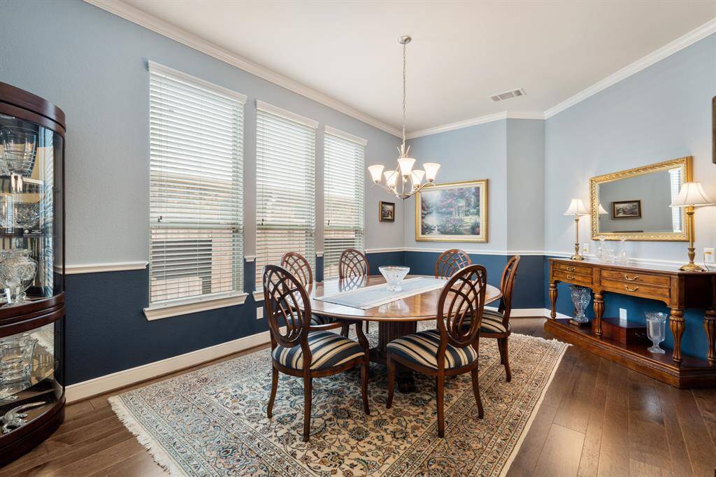 This spacious living room features a cozy fireplace, and ample natural light from large windows overlooking the backyard. The Benjamin Moore neutral tones and open layout create a welcoming and comfortable atmosphere. Added 5.1 surround system with high ceiling internal speakers. *TV excluded.