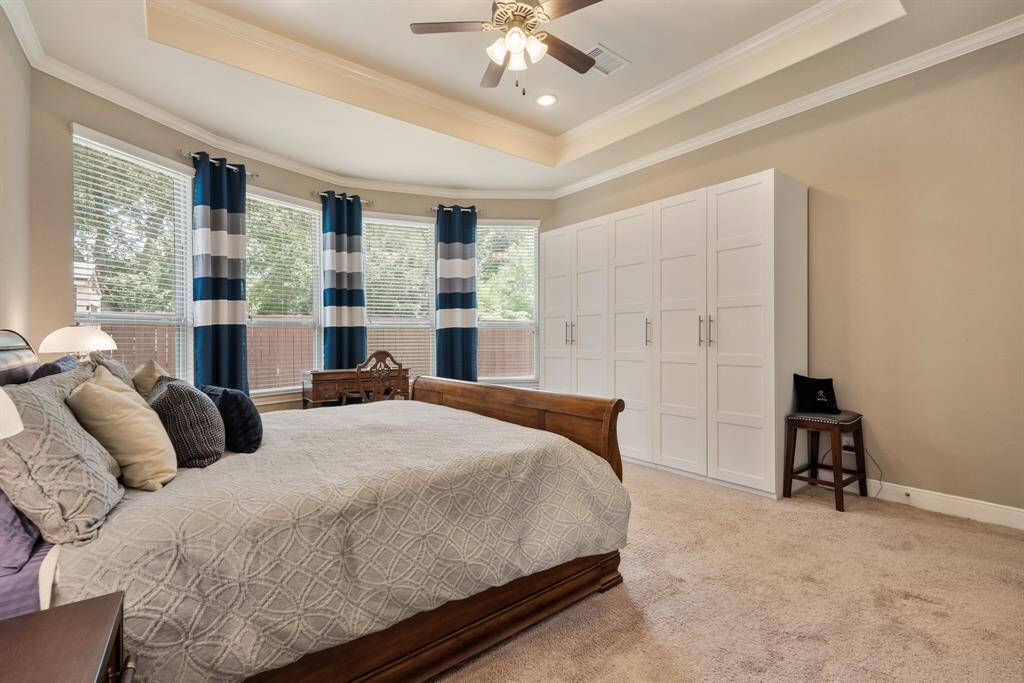 This modern kitchen features an open layout with sleek stainless steel appliances, a central island with granite countertops, pendant lighting, and ample cabinetry. Added 2 back wall double cabinets for storage above shelving in the kitchen pantry.