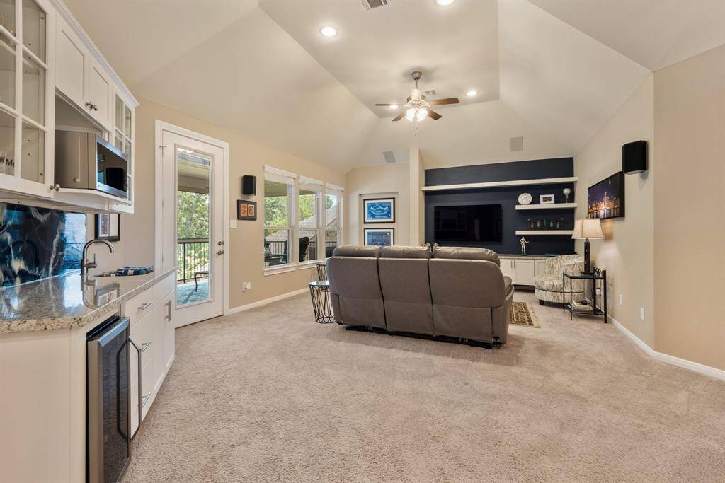 Spacious primary bedroom with neutral tones, large windows, box ceiling and ample natural light. Featuring additional storage with a custom Elfa Closet wardrobe system from the Container Store.