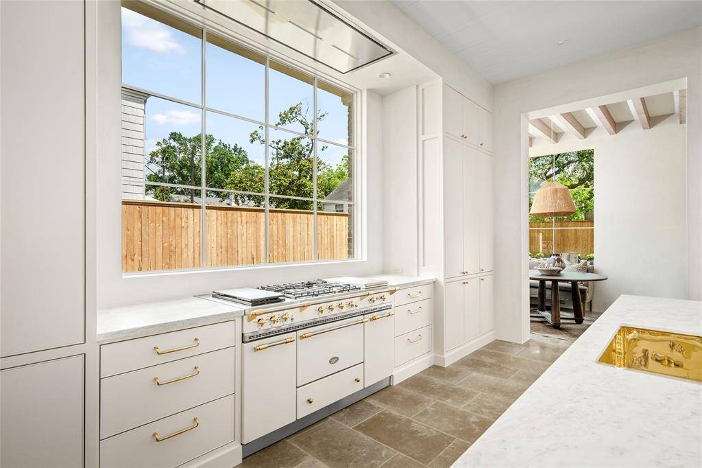 A wall of windows and a state of the art remote controlled concealed vent over the Select Lacanche range with 5 burners, dual ovens and a warming box